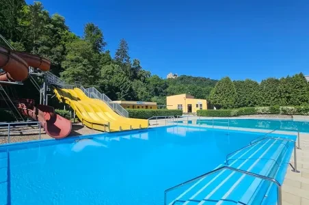 Modrý bazén s žlutými skluzavkami v aquaparku