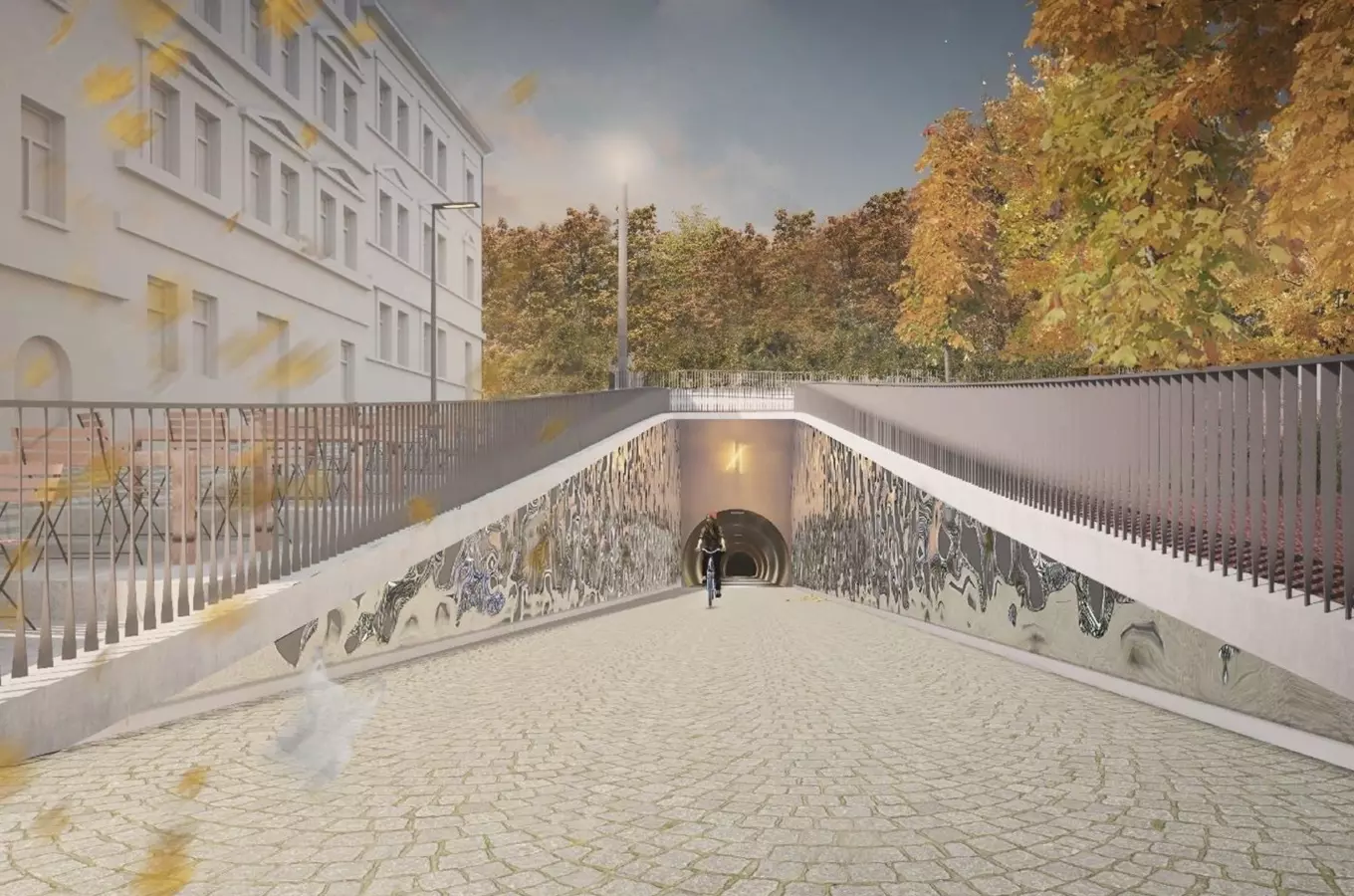 Vstup do podjezdu s uměleckými nástřiky na zdech a cyklista.