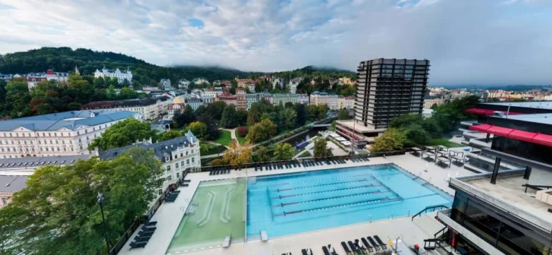 Outdoor heated swimming pool complex with city view