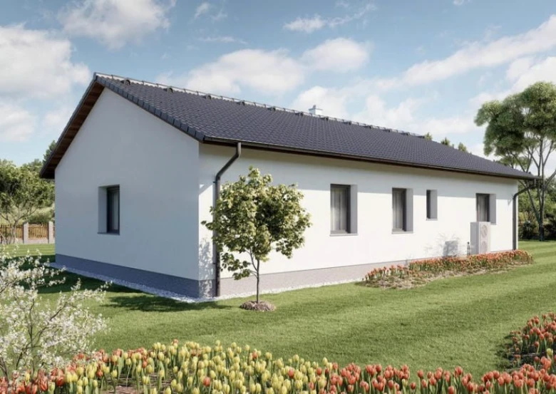 Moderní bílý modulový dům s tmavou střechou na trávníku.