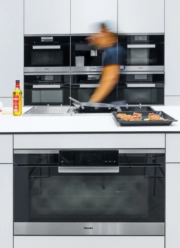 Kitchen with cooktop and ovens